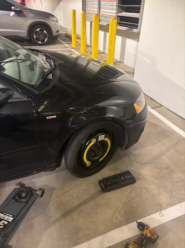 Spare tire installed on an Audi in a parking garage